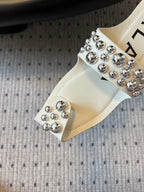 ALAIA FOLDED FLAT MULES WITH SPHERES ON WHITE CALFSKIN