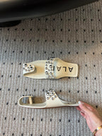 ALAIA FOLDED FLAT MULES WITH SPHERES ON WHITE CALFSKIN