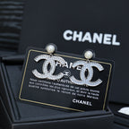 DOUBLE C EARRINGS IN SILVER METAL WITH BLACK SNOWFLAKE EMBOSSED ON WHITE ENAMEL
