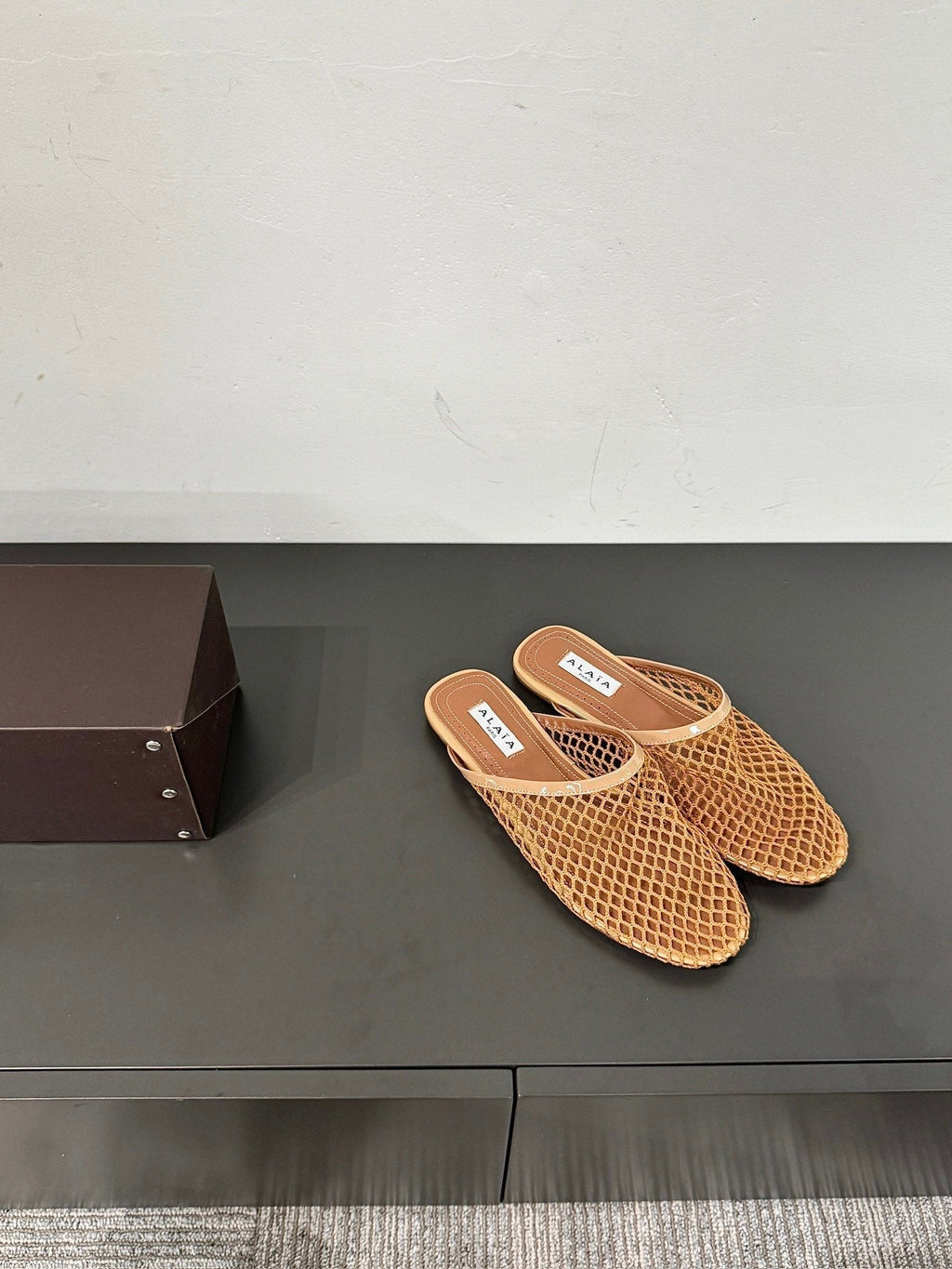 ALAIA FLAT MULES IN COPPER BROWN MESH FISHNET