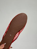 ALAIA FLAT MULES IN CHERRY RED MESH FISHNET