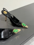 GREEN GEM-STUDDED SLINGBACK PUMPS IN BLACK PATENT CALFSKIN