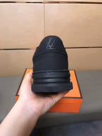 LV TRAINER IN EMBOSSED BLACK SUEDE