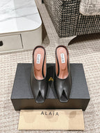 ALAIA SPIKE JEWEL MULES IN BLACK CALFSKIN