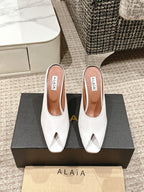 ALAIA SPIKE JEWEL MULES IN WHITE CALFSKIN