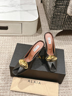 ALAIA SPIKE JEWEL MULES IN BLACK CALFSKIN WITH GOLD HARDWARE