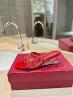 ROCKSTUD MULE SANDALS IN CHERRY RED CALFSKIN AND TRANSPARENT PVC FILM